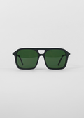 Black sunglasses with green lenses on a light gray background