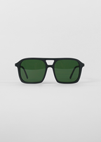 Black sunglasses with green lenses on a light gray background