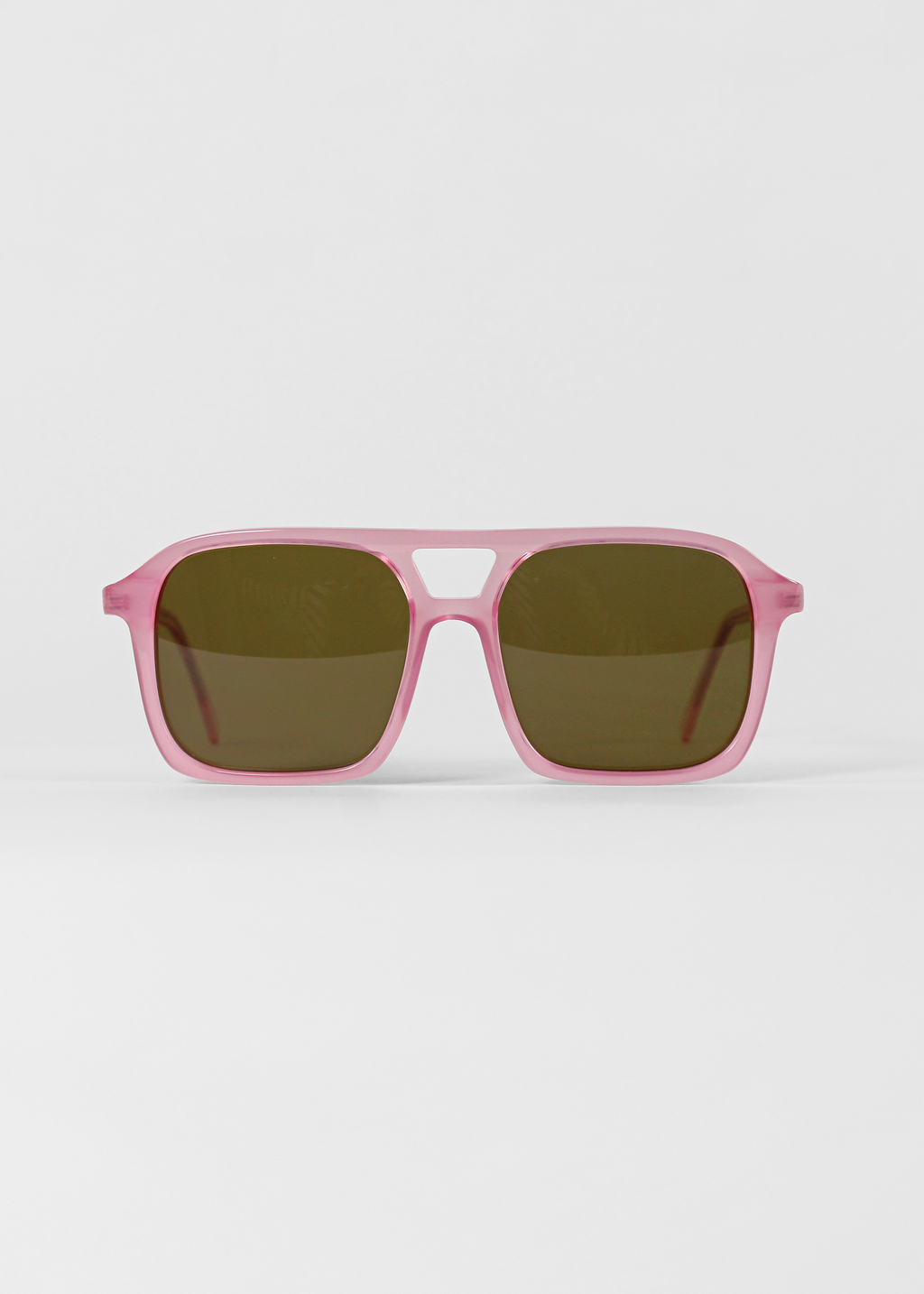 Pink sunglasses with dark lenses on a white background