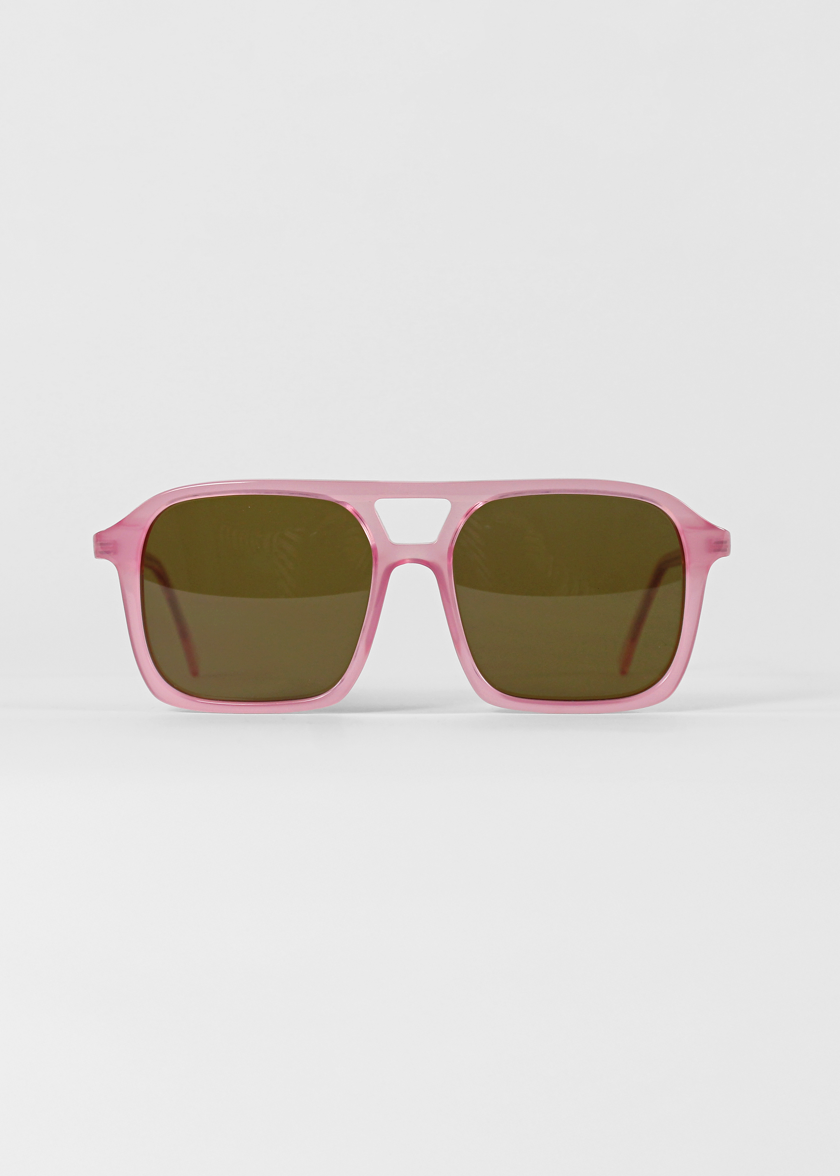 Pink sunglasses with dark lenses on a white background
